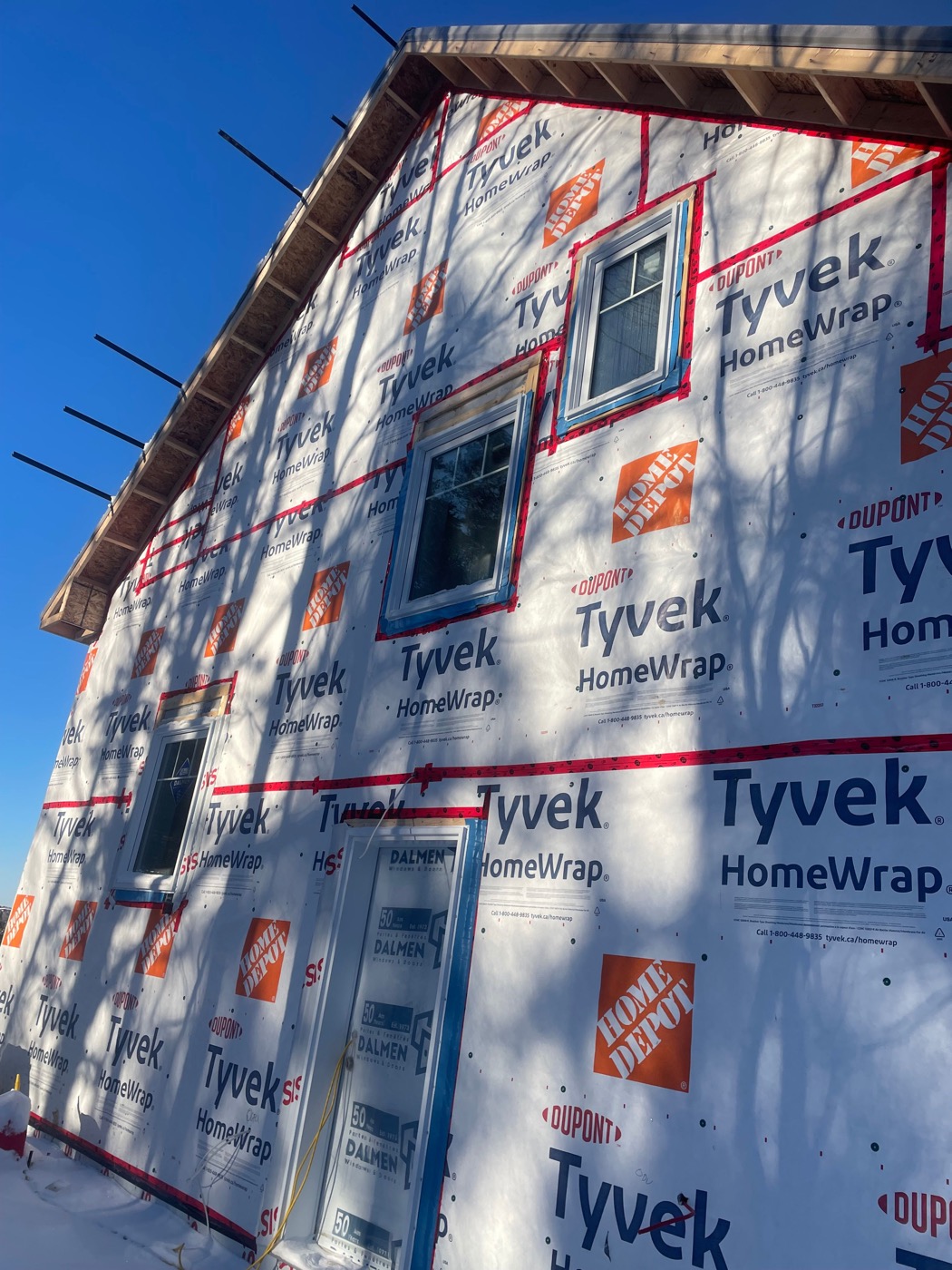 Weather-barrier seams and window openings prepared for siding